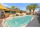 Inviting pool area with a covered pool, lush palm trees, and a serene outdoor ambiance at 2426 La Pluma St, Henderson, NV 89014