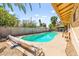 Captivating backyard pool surrounded by privacy fencing, with comfortable seating and lush trees at 2426 La Pluma St, Henderson, NV 89014
