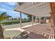 Large covered patio with a view of a small lake at 2537 Seascape Dr, Las Vegas, NV 89128