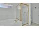 Close-up of a bathroom showing the bathtub and glass enclosed shower stall at 2537 Seascape Dr, Las Vegas, NV 89128