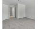 Spacious bedroom features neutral tones and doorway to walk-in closet and bathroom at 2537 Seascape Dr, Las Vegas, NV 89128