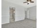 Spacious bedroom featuring neutral tones, ceiling fan, and adjoining bathroom and walk-in closet at 2537 Seascape Dr, Las Vegas, NV 89128