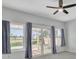 Bedroom features a ceiling fan, windows, sliding glass doors that lead to the patio and backyard at 2537 Seascape Dr, Las Vegas, NV 89128