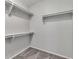 Walk-in closet featuring neutral carpet and built-in shelving at 2537 Seascape Dr, Las Vegas, NV 89128