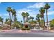 Community entrance featuring a guard house, gate and beautiful palm trees at 2537 Seascape Dr, Las Vegas, NV 89128