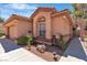Inviting single-story home with an arched window and a well-manicured desert landscaped yard at 2537 Seascape Dr, Las Vegas, NV 89128