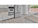 Bright kitchen features stainless steel appliances, white cabinetry, and tile flooring at 2537 Seascape Dr, Las Vegas, NV 89128