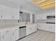 Bright kitchen features tile floors, stainless steel appliances, and white cabinets at 2537 Seascape Dr, Las Vegas, NV 89128