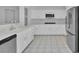 Bright kitchen with stainless steel appliances, white cabinets, and tile floors for easy maintenance at 2537 Seascape Dr, Las Vegas, NV 89128