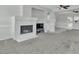 Bright open living room features a stone fireplace, ceiling fan, and a spacious open floor plan at 2537 Seascape Dr, Las Vegas, NV 89128