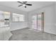 Open-concept living space with carpet, tile, a large window, and sliding glass doors at 2537 Seascape Dr, Las Vegas, NV 89128