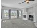 Spacious living room with fireplace, ceiling fan, and sliding glass doors leading to patio at 2537 Seascape Dr, Las Vegas, NV 89128