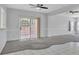 Spacious living room with carpet, tile, ceiling fans, and a sliding glass door to the backyard at 2537 Seascape Dr, Las Vegas, NV 89128