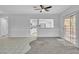 Open-concept living space with carpet, tile, and a pass-through window into the kitchen at 2537 Seascape Dr, Las Vegas, NV 89128