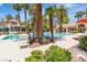 Resort-style community pool surrounded by lush landscaping and comfortable seating areas at 2537 Seascape Dr, Las Vegas, NV 89128