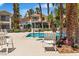 Inviting community pool with comfortable lounge chairs and lush palm tree landscaping at 2537 Seascape Dr, Las Vegas, NV 89128
