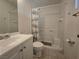 Bright bathroom featuring a white vanity, toilet, and shower-tub combination with a shower curtain at 256 Winona Ter, Henderson, NV 89015