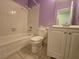 Bathroom with white tile, toilet, vanity and lavender paint at 256 Winona Ter, Henderson, NV 89015