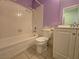 Bathroom with white tile, toilet, vanity and lavender paint at 256 Winona Ter, Henderson, NV 89015