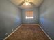 Bedroom features carpet floors, blue walls, ceiling fan and window at 256 Winona Ter, Henderson, NV 89015