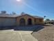 Exterior view of a yellow house with a driveway and garage at 256 Winona Ter, Henderson, NV 89015