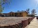 Single-story home with low-maintenance desert landscaping and a brick retaining wall at 256 Winona Ter, Henderson, NV 89015