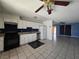 Bright, open kitchen with white cabinetry, tile floors and seamlessly connected to the living area at 256 Winona Ter, Henderson, NV 89015