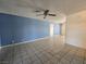 Bright living room featuring tile flooring, ceiling fan, and neutral-colored walls at 256 Winona Ter, Henderson, NV 89015
