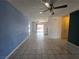 Spacious living room features tile flooring, ceiling fan, neutral paint and flows into the kitchen at 256 Winona Ter, Henderson, NV 89015