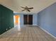 Inviting living room with tile flooring, neutral blue walls, and access to the kitchen at 256 Winona Ter, Henderson, NV 89015