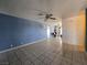 Open living room boasts neutral walls, tile floors, ceiling fan, and easy access to the kitchen at 256 Winona Ter, Henderson, NV 89015