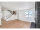 Bright living area with hardwood floors, a brick fireplace, and modern staircase at 2611 Siesta Ave, Las Vegas, NV 89121