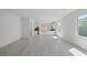 Bright, open-concept living room and kitchen with large windows at 2612 Lily Point St, Las Vegas, NV 89156