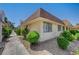 A well-kept exterior with a brown roof, secure windows, and rock landscaping at 2732 Heritage Ct, Las Vegas, NV 89121