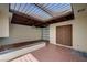 Enclosed garage with skylights, terracotta tile flooring, a unique rock garden, and a brick water feature at 2732 Heritage Ct, Las Vegas, NV 89121