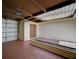 Enclosed patio with skylight, red tile floor, garage access, storage, and brick planters at 2732 Heritage Ct, Las Vegas, NV 89121