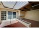 Well-lit garage featuring terracotta tile flooring, a brick water feature, and a glass paneled back door at 2732 Heritage Ct, Las Vegas, NV 89121
