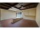 Spacious enclosed garage with skylights, terracotta tile flooring, a brick water feature, and storage cabinets at 2732 Heritage Ct, Las Vegas, NV 89121