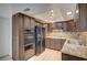 Spacious kitchen with lots of cabinets, granite counters, and a sleek black refrigerator enhancing its contemporary style at 2732 Heritage Ct, Las Vegas, NV 89121