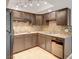 Well-equipped kitchen with brown cabinets, granite countertops, and stainless steel appliances for modern convenience at 2732 Heritage Ct, Las Vegas, NV 89121