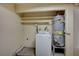 Laundry area with a washing machine, water heater, and shelving for storage at 2732 Heritage Ct, Las Vegas, NV 89121