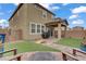 Backyard with patio, artificial turf, fire pit, and views of the house at 2742 Zazzera Ct, Henderson, NV 89044