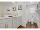 Well-lit bathroom with double vanity, modern fixtures, and wood-look flooring at 2742 Zazzera Ct, Henderson, NV 89044