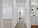 Bright hallway leading to bedrooms and bathroom featuring neutral walls and carpet at 2742 Zazzera Ct, Henderson, NV 89044