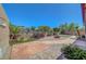Landscaped backyard with decorative lighting, fire pit, artificial grass, patio, and privacy wall at 2779 Kindeace Ave, Henderson, NV 89044