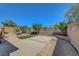 Spacious backyard with patio, fire pit, artificial grass, lush landscaping, and privacy wall at 2779 Kindeace Ave, Henderson, NV 89044
