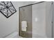 Bathroom with a shower featuring a glass door, grab bar, and decorative towel rack at 2779 Kindeace Ave, Henderson, NV 89044