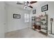 Bright bedroom with ceiling fan, tile floors, decorative shelving and plantation shutters at 2779 Kindeace Ave, Henderson, NV 89044