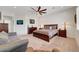 The spacious bedroom has a ceiling fan, couch, and dark wood furniture with bedside lamps at 2779 Kindeace Ave, Henderson, NV 89044