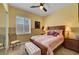 Bedroom featuring a comfortable bed, decorative chair, and a window with plantation shutters at 2779 Kindeace Ave, Henderson, NV 89044